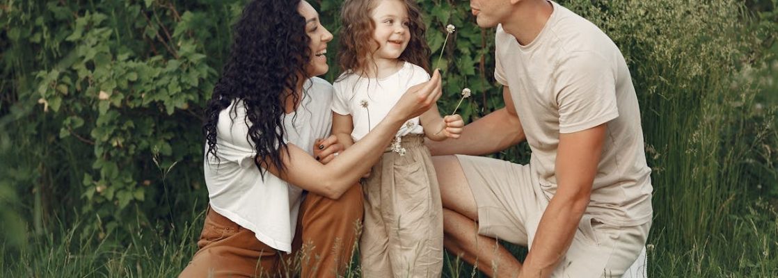 A joyful family enjoying time together in a lush green meadow, capturing love and bonding.